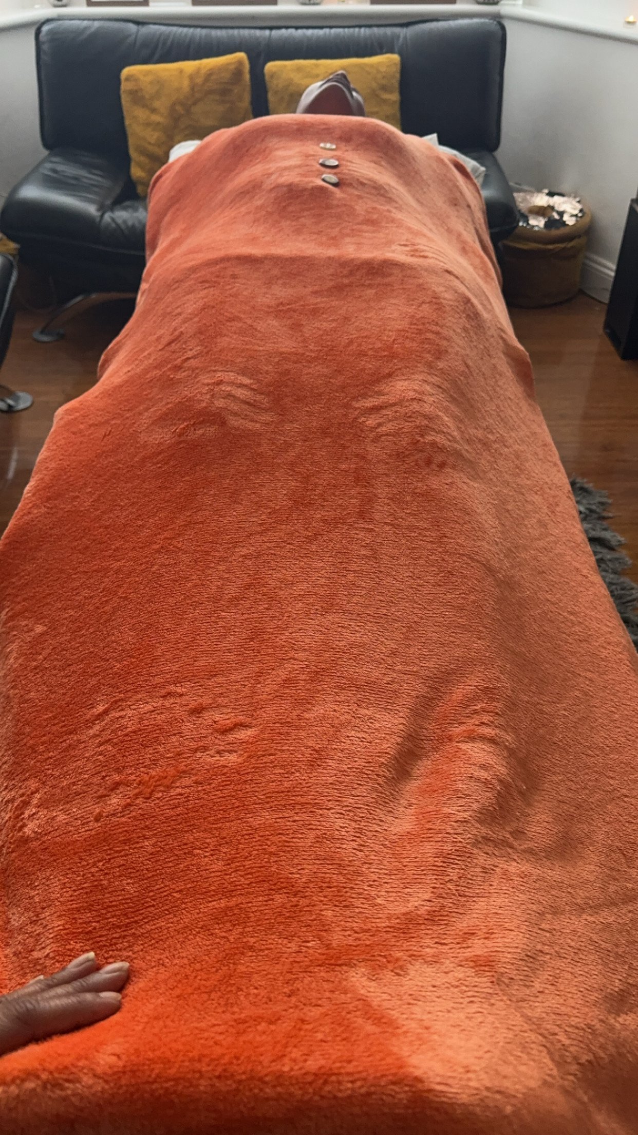 Client laying on the Therapy Couch/bed in a meditative state, whilst receiving Energy healing in London