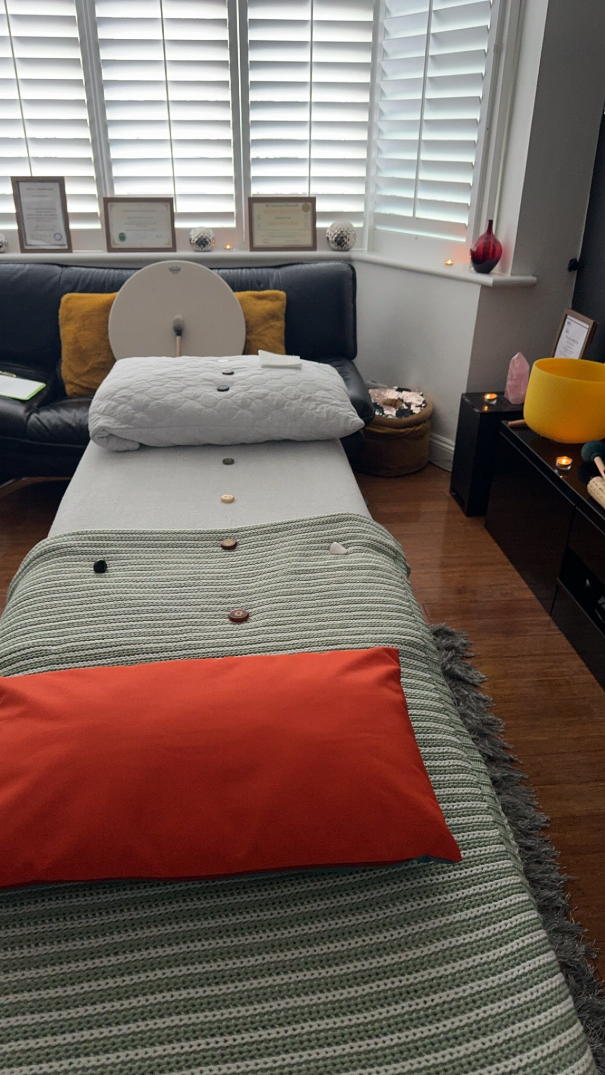 Therapy Couch/bed set up for a client with pillows, crystals and blankets