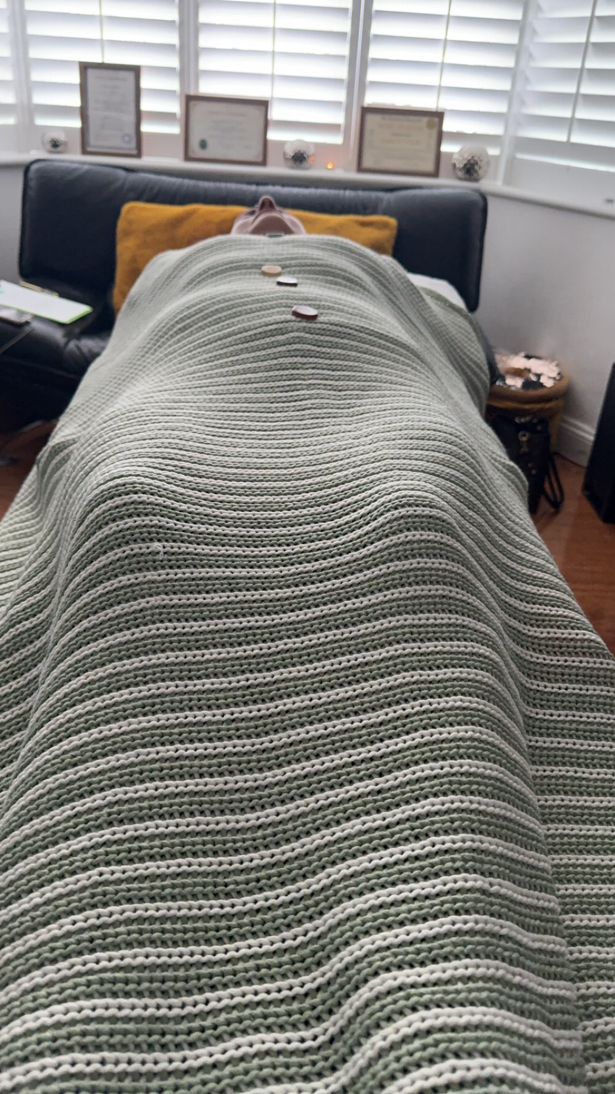 Client receives Shamanic healing on a therapy/Couch