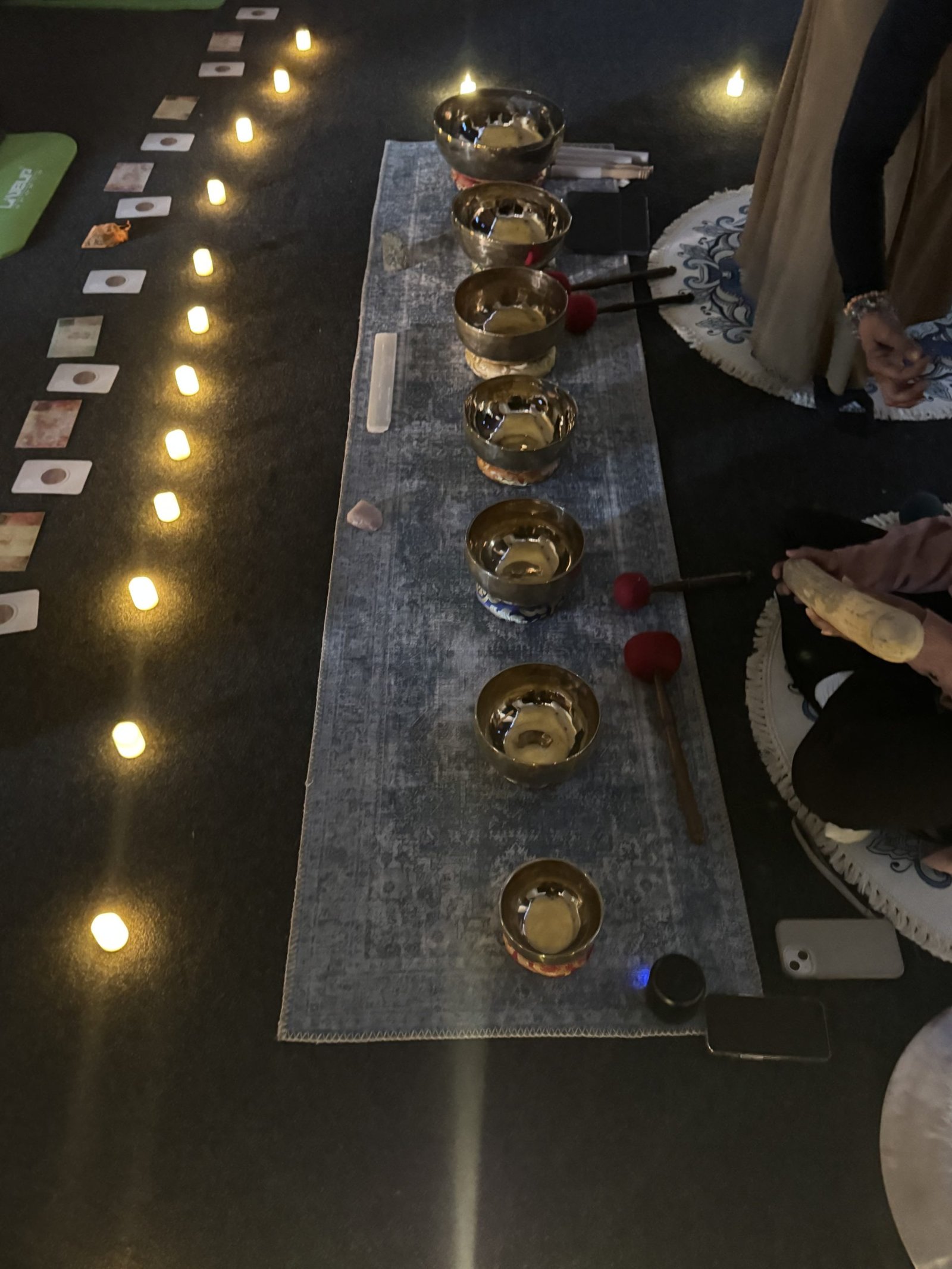 Tibetan Singing bowls on a rug with candles around