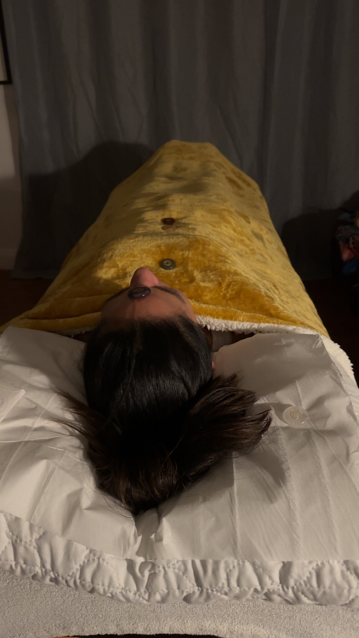 Client Laying on Therapy/Couch having a Reiki and Crystal healing session with Reiki therapist Dahni