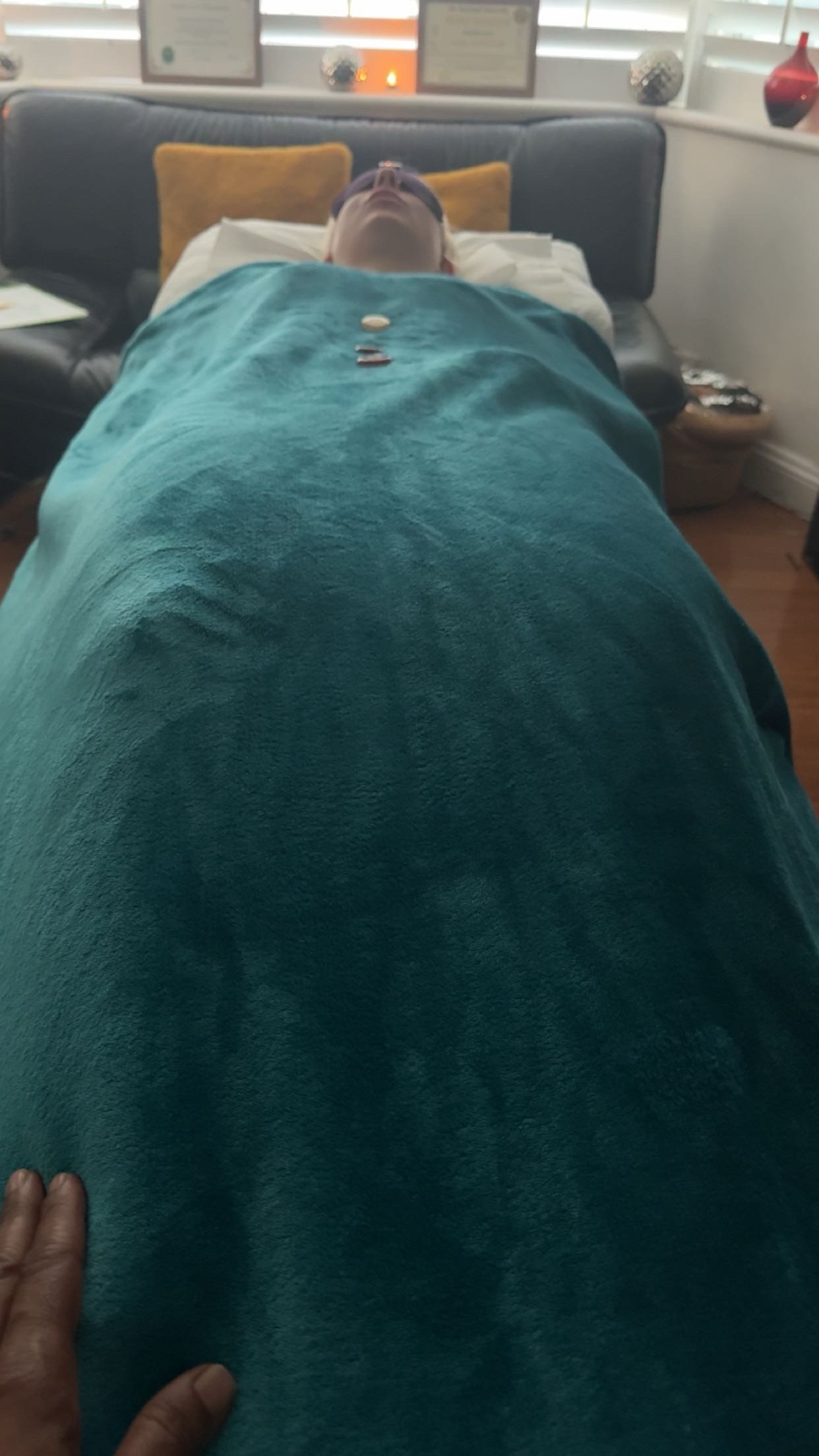 Client receives Reiki healing whilst laying in a meditative state on the therapy Couch/bed