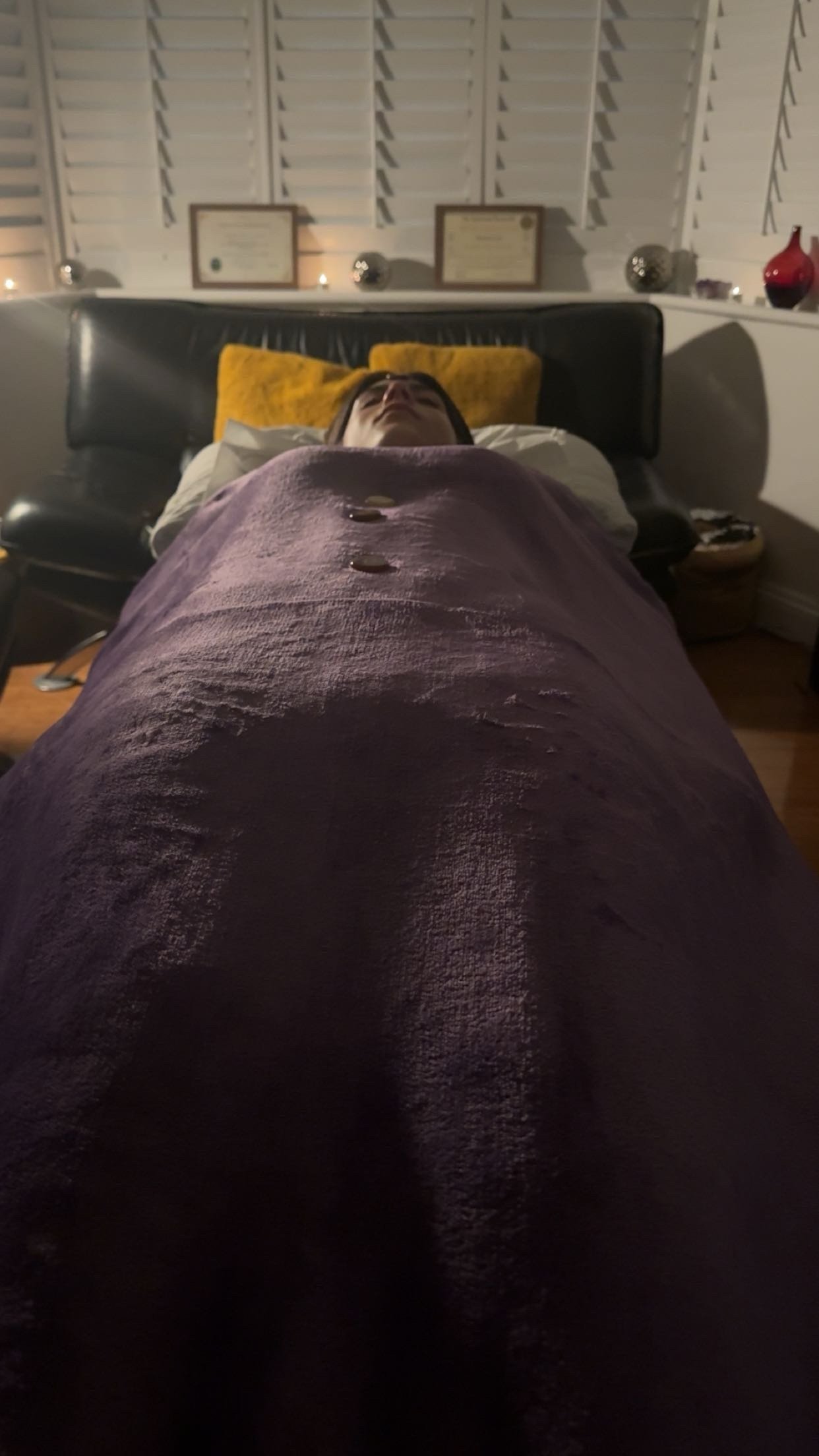 Client lays on therapy Couch/Bed receiving Reiki Energy healing with Crystals placed along the Chakras