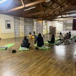 People preparing to lay down for sound healing at a sound bath being held by Dahni sound healing practitioner
