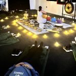 Sound bath event where people are laying down receiving sound healing by wellness practitioner Dahni