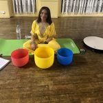 Dahni sitting on the floor with Quartz Crystal sound bowls