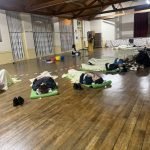 People laying down on mats receiving sound healing at a sound bath