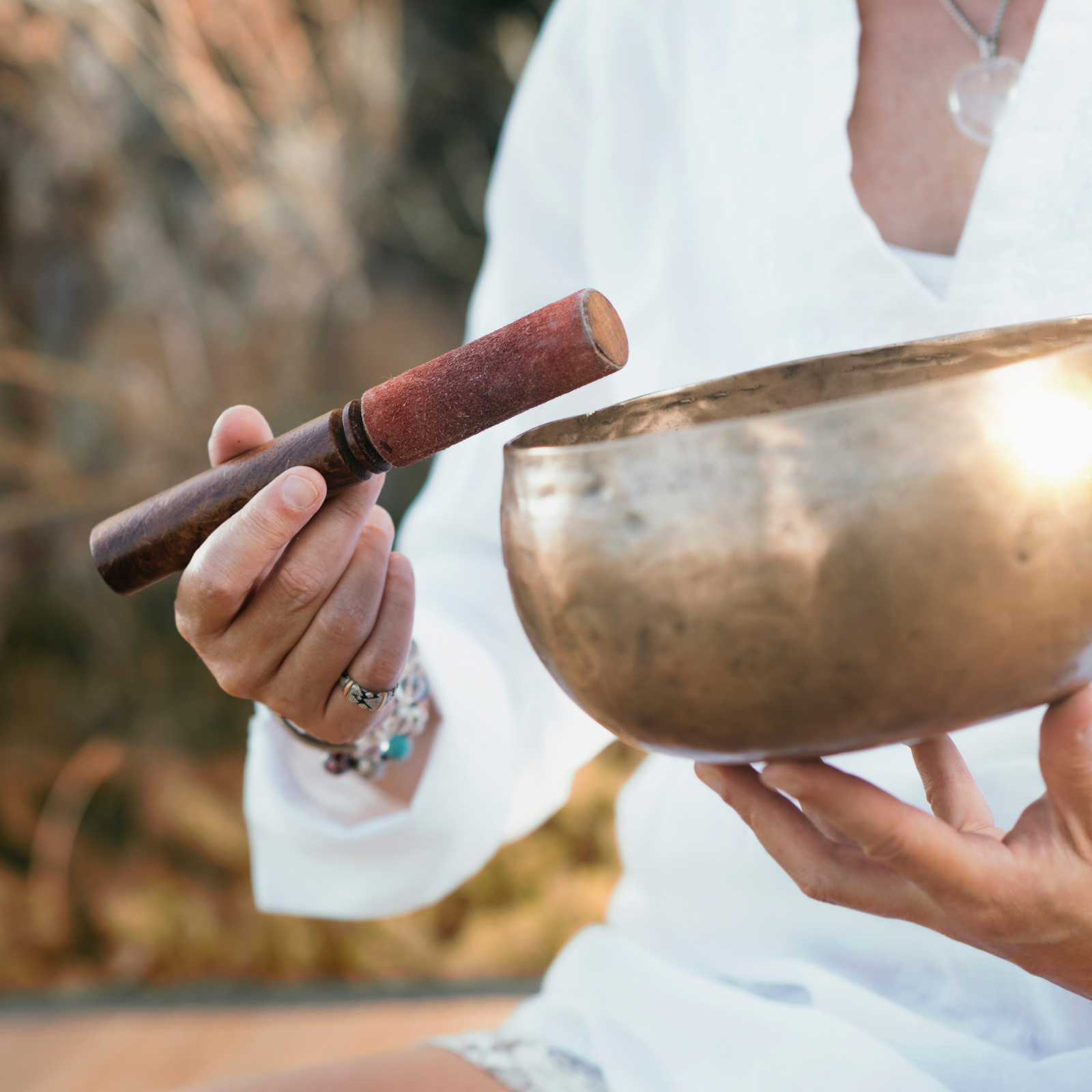A picture of hands playing a sound bowl